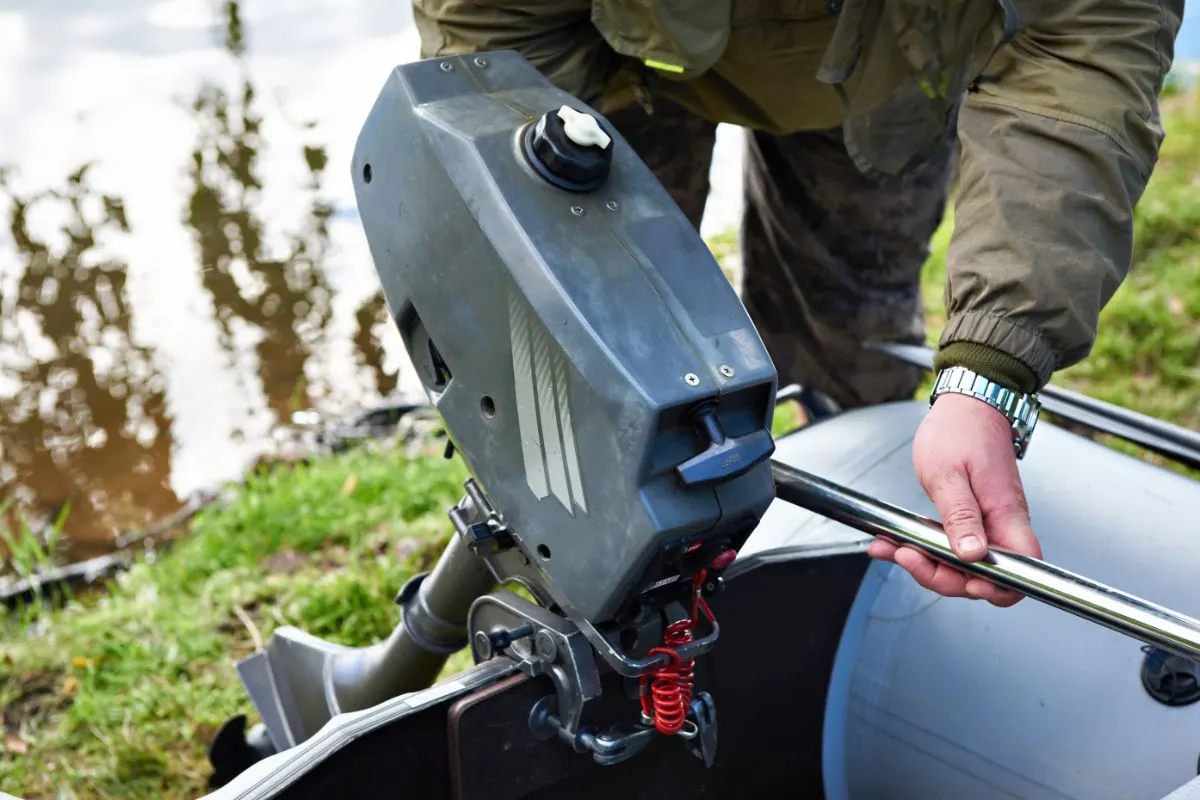 A fisherman assembling his the motor.