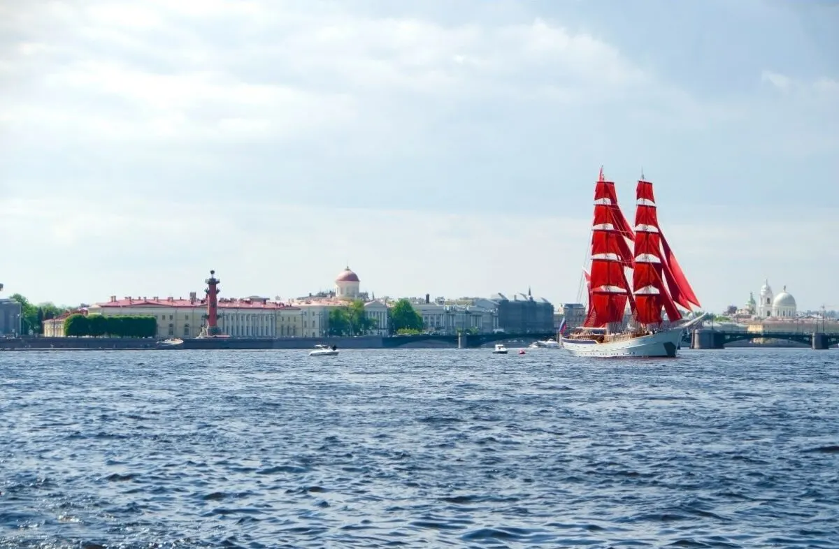 A ship with red sails in the ocean.