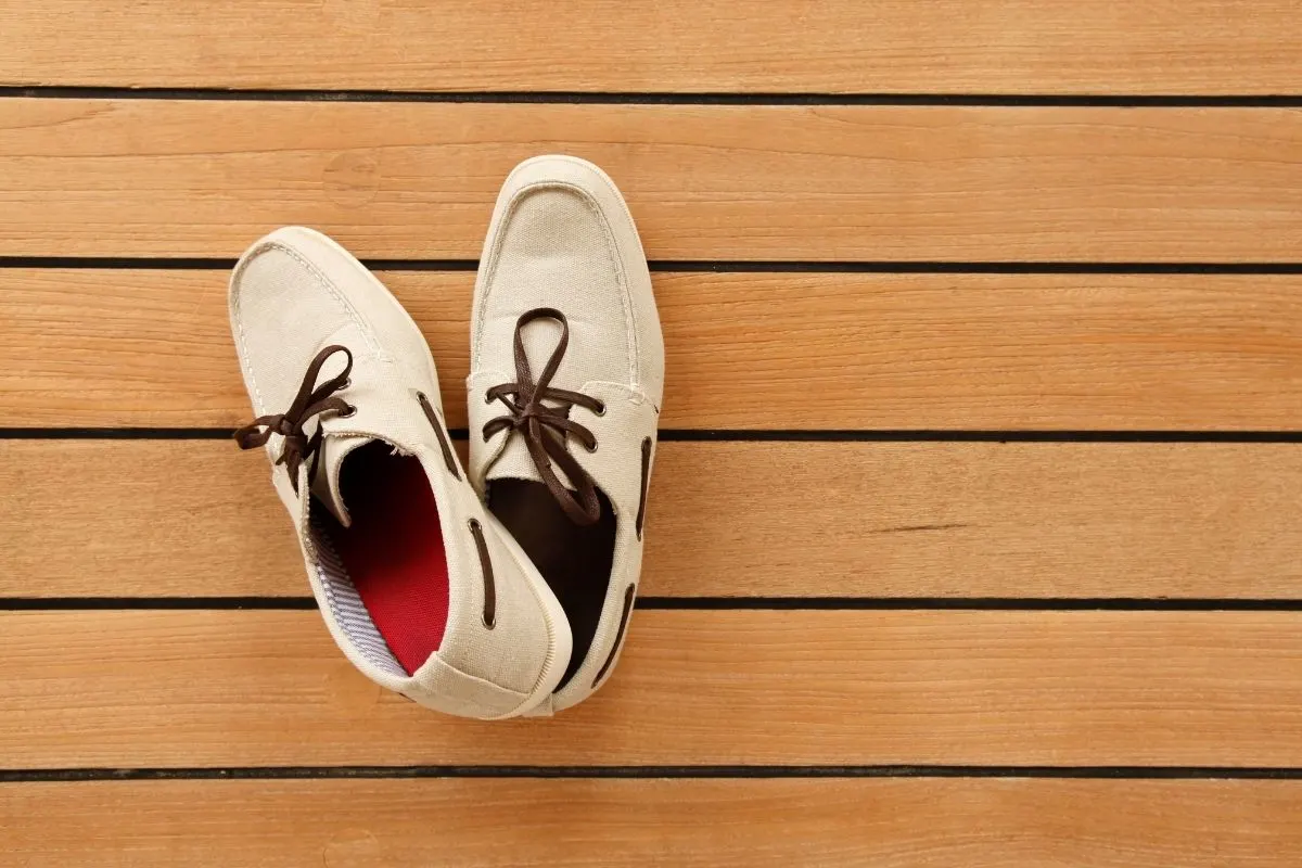 A boat shoes on a wooden surface.