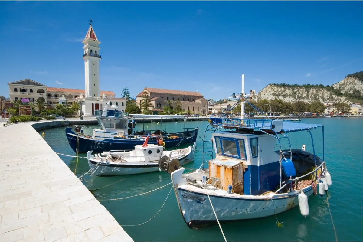 Three deifferent fishing boats lined up at the port.