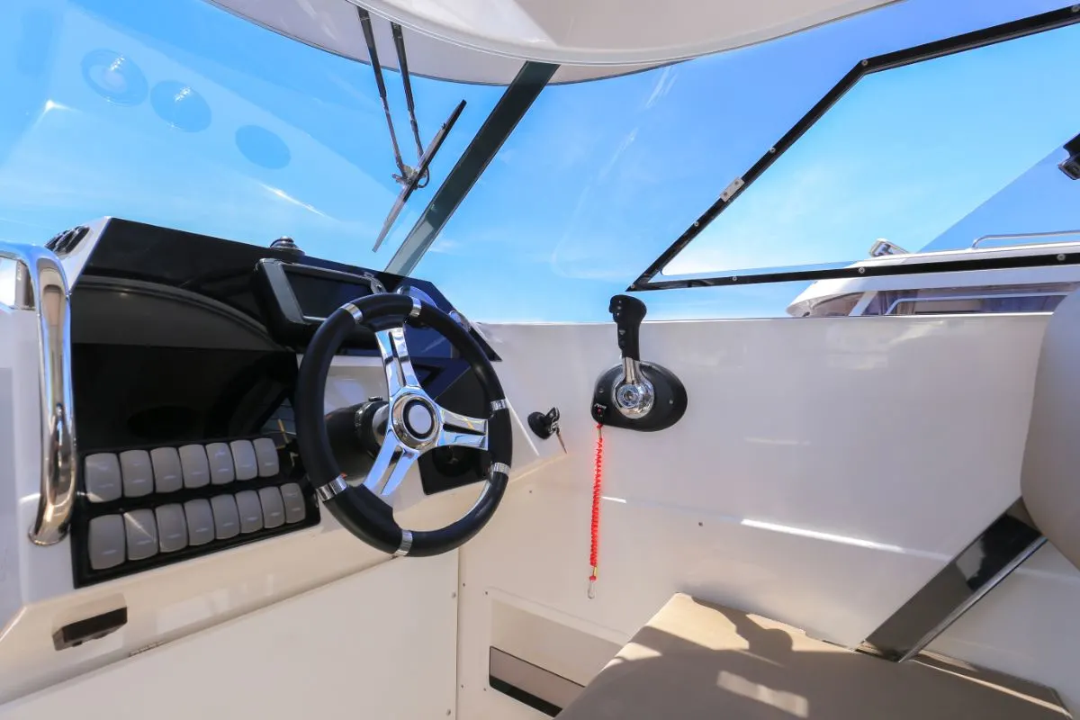 A black and white themed cockpit motor and steering wheel.