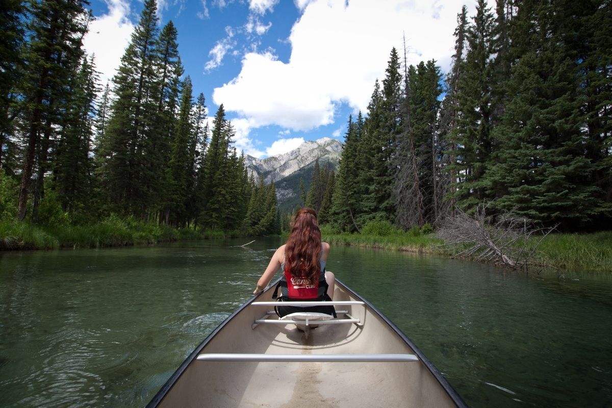 A photo of a woman canoeing.