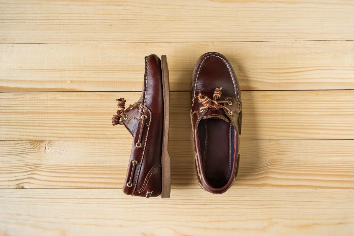 A brown boat shoes on wooden surface.