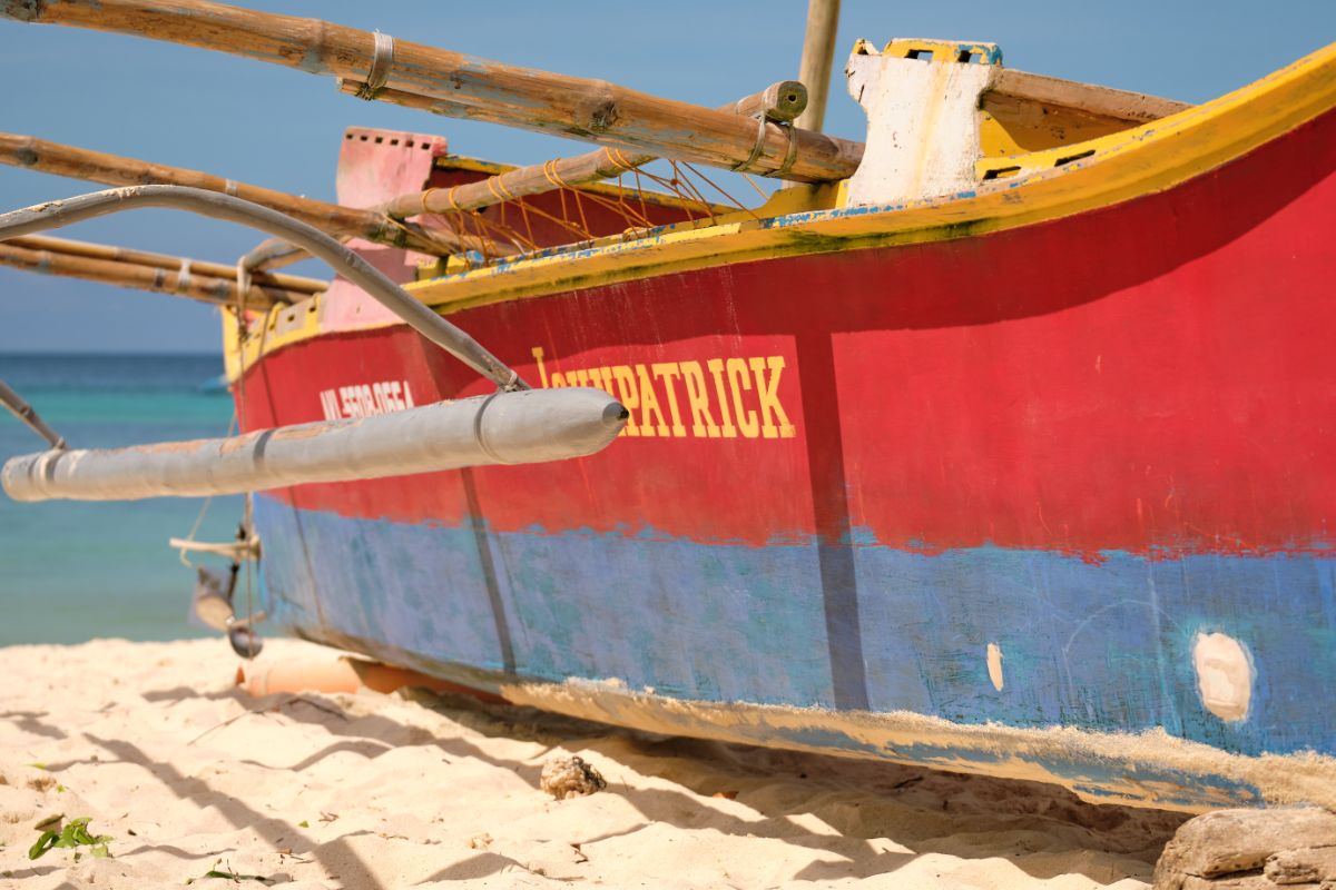 A red and blue engined boat named John Patrick.