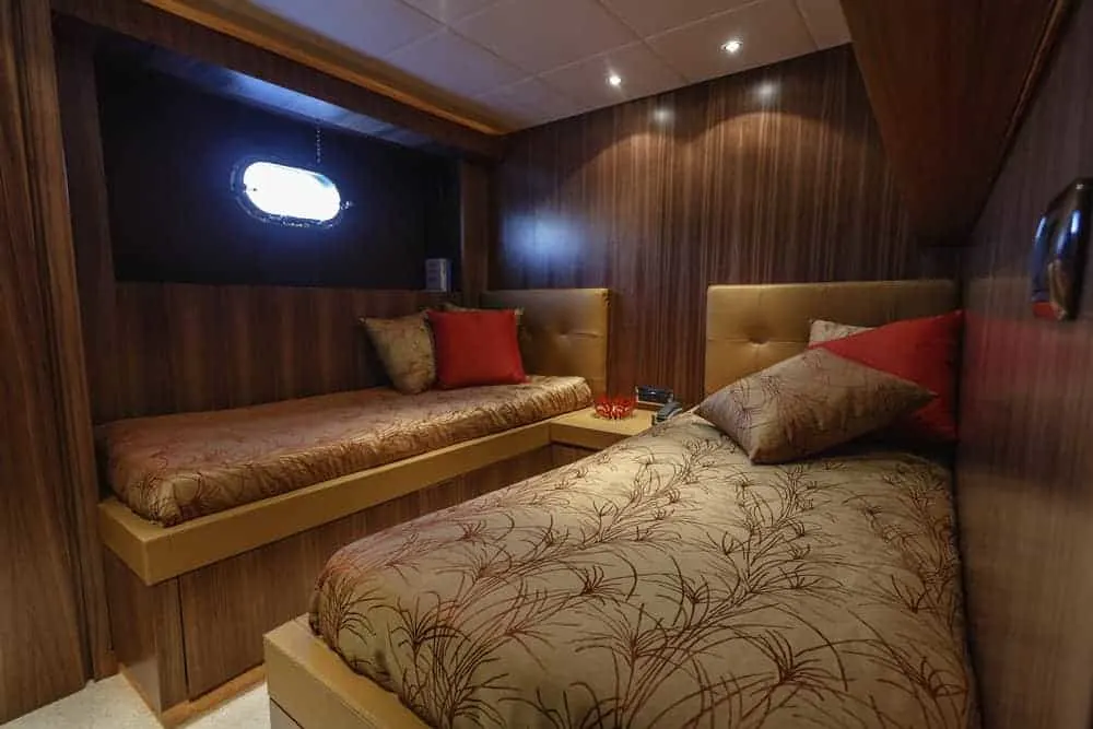 guest bedroom on yacht with two beds