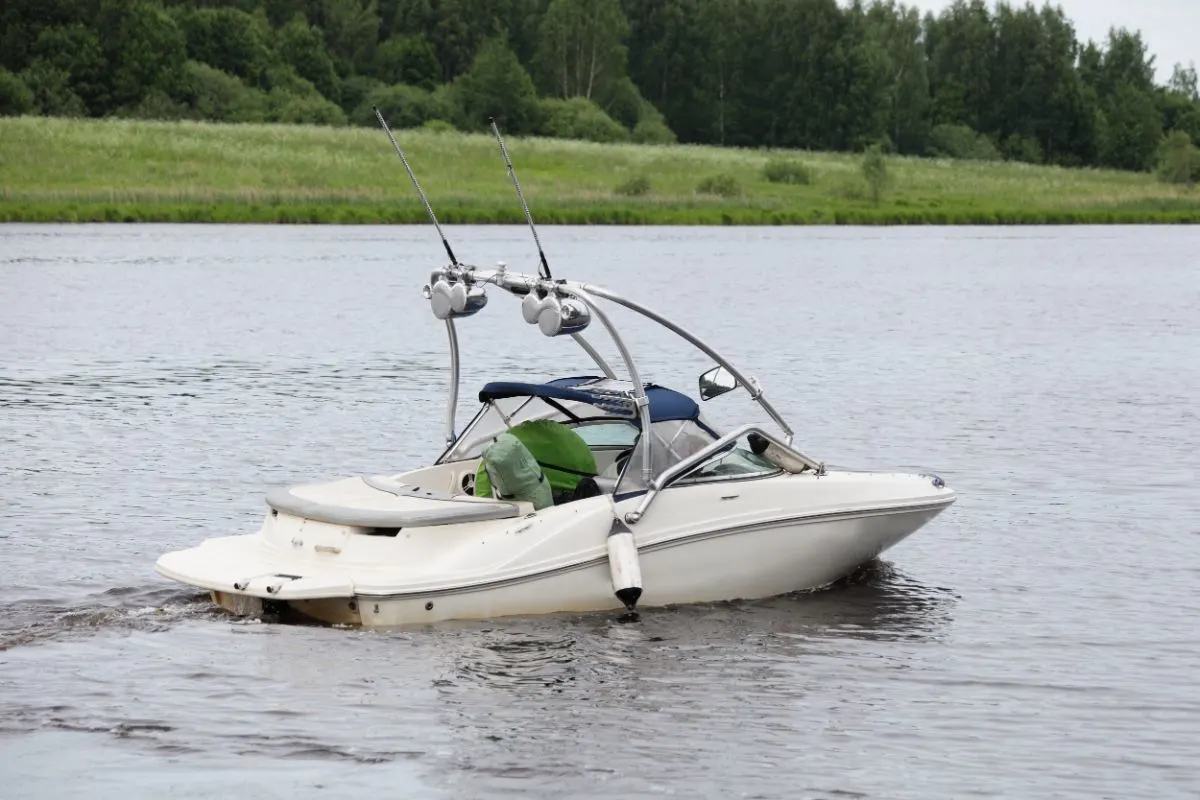 A white motor boat on the river water.