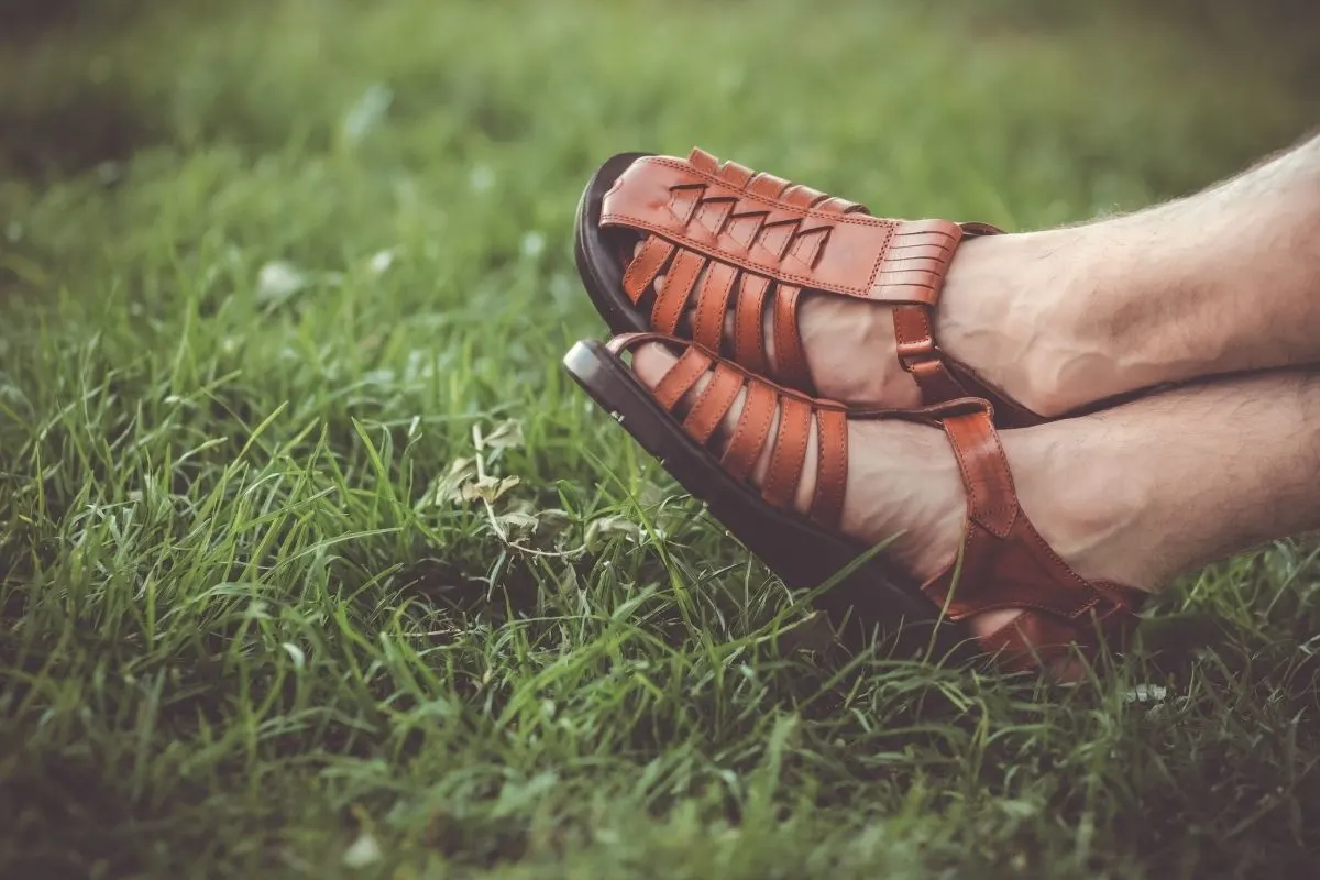 A man wearing brown tevas sandal.