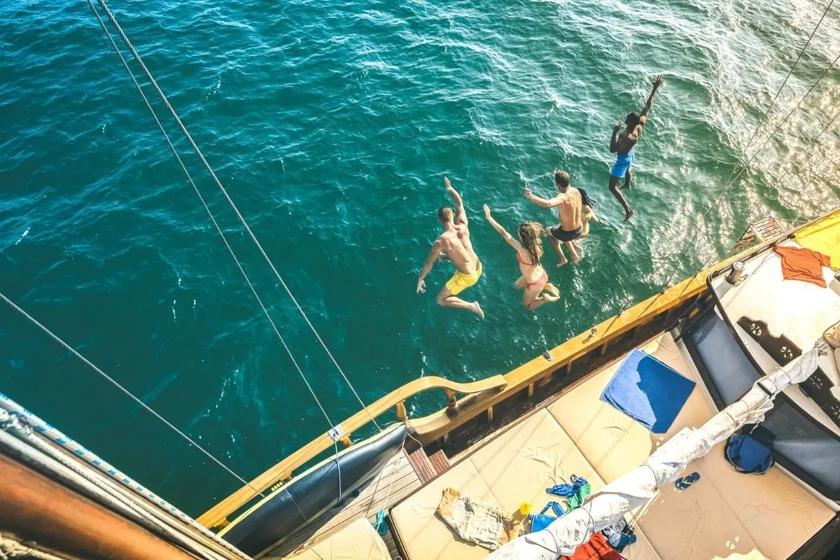 Aerial view of millenial jumping of the yacht.