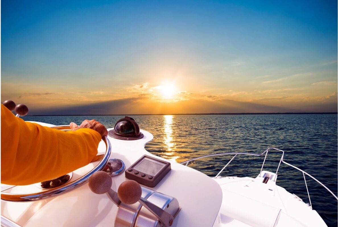 Watching the sun set in the calm ocean with a steering wheel.