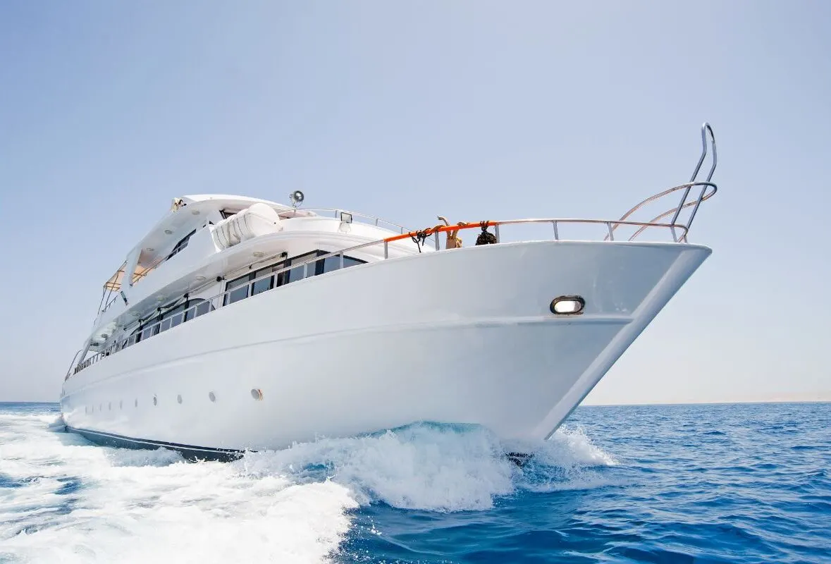 A white large motor yacht under way at sea.