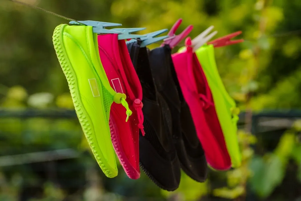 A pairs of aqua shoes drying on the sun.