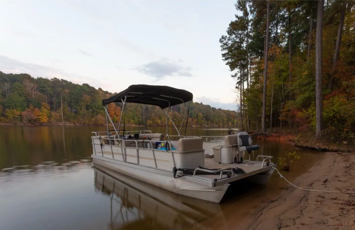 A photo of pontoon boat beached at falls lake.