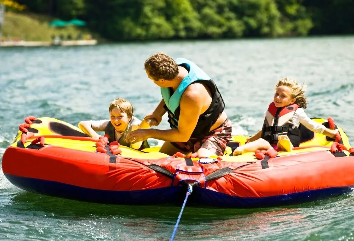 A family enjoying fun tubing on the lake.