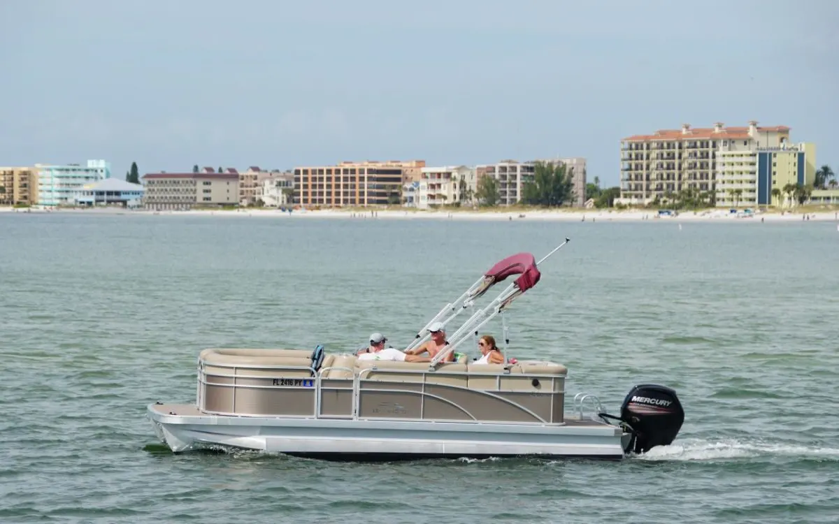 A pontoon boat moving o the bay.