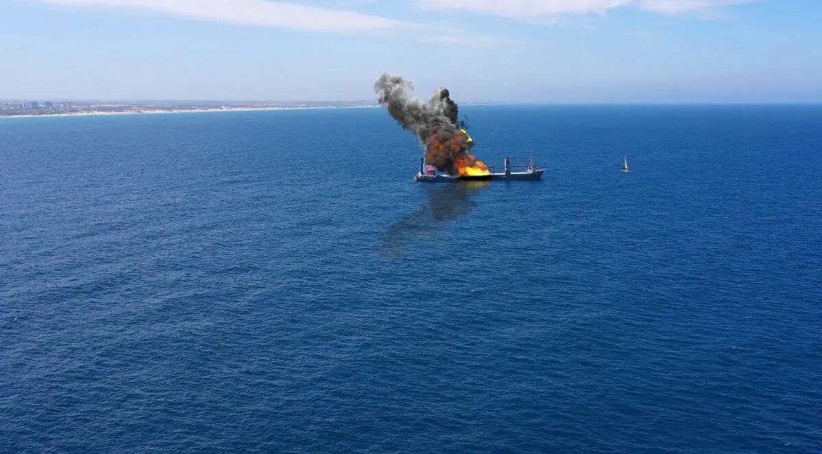 Cargo ship caught fire on the sea.