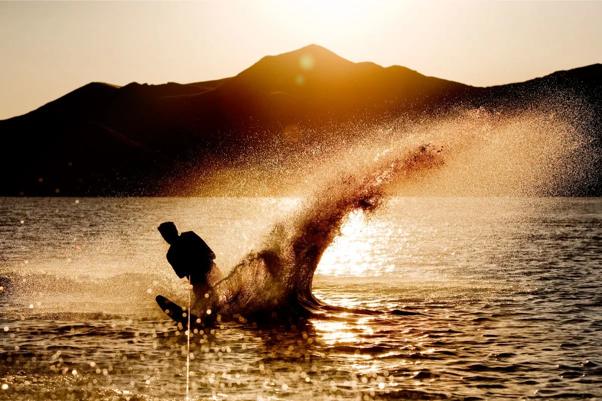 A silhouette photo of man water skiing.