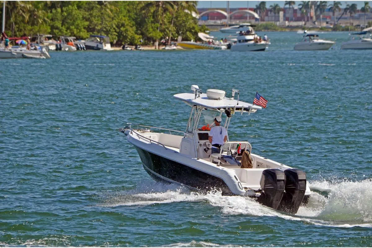 A man navigating his own small fishing motor boat in heading towards Monument Island.