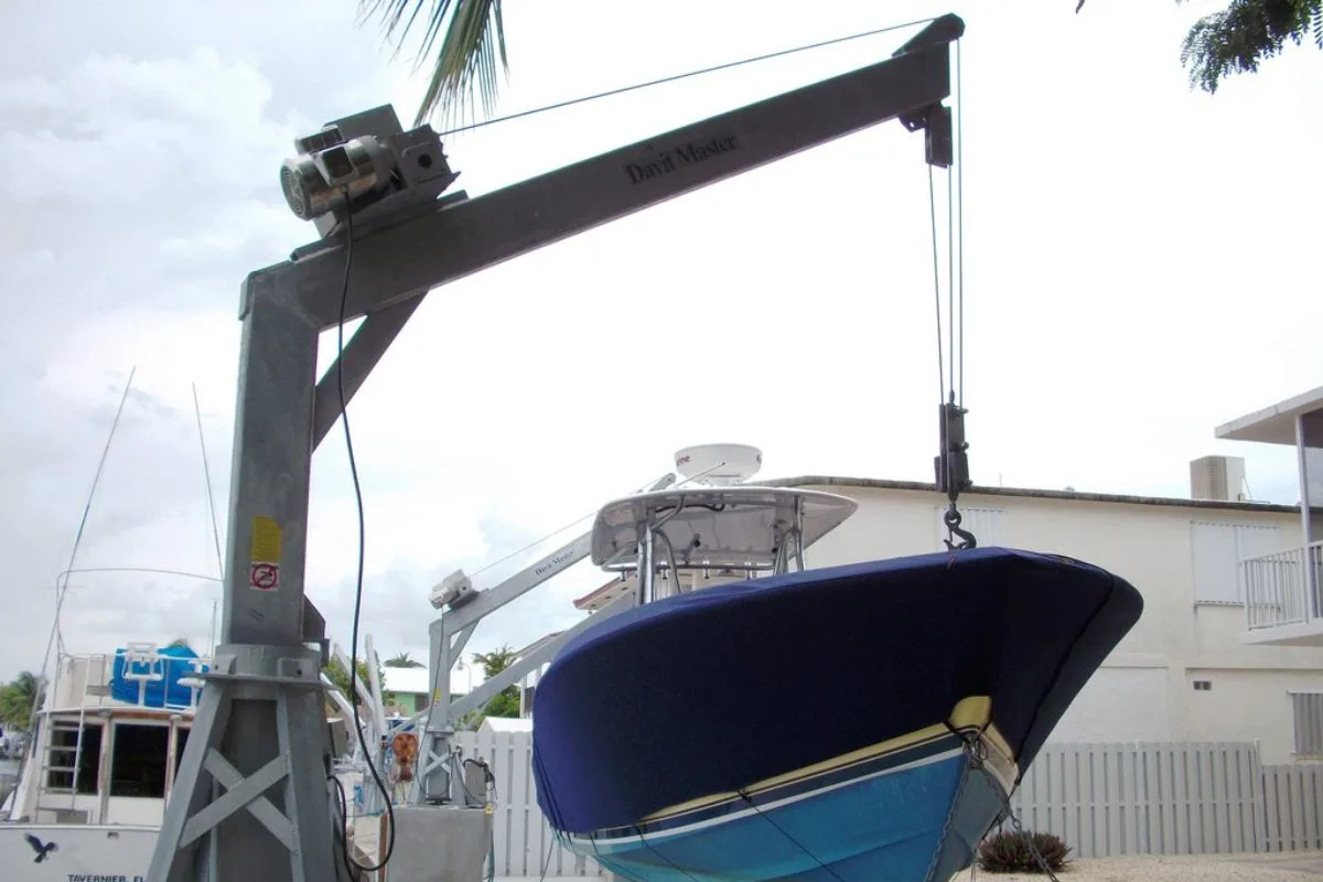 A photo of a boat lifted using davit lifts.