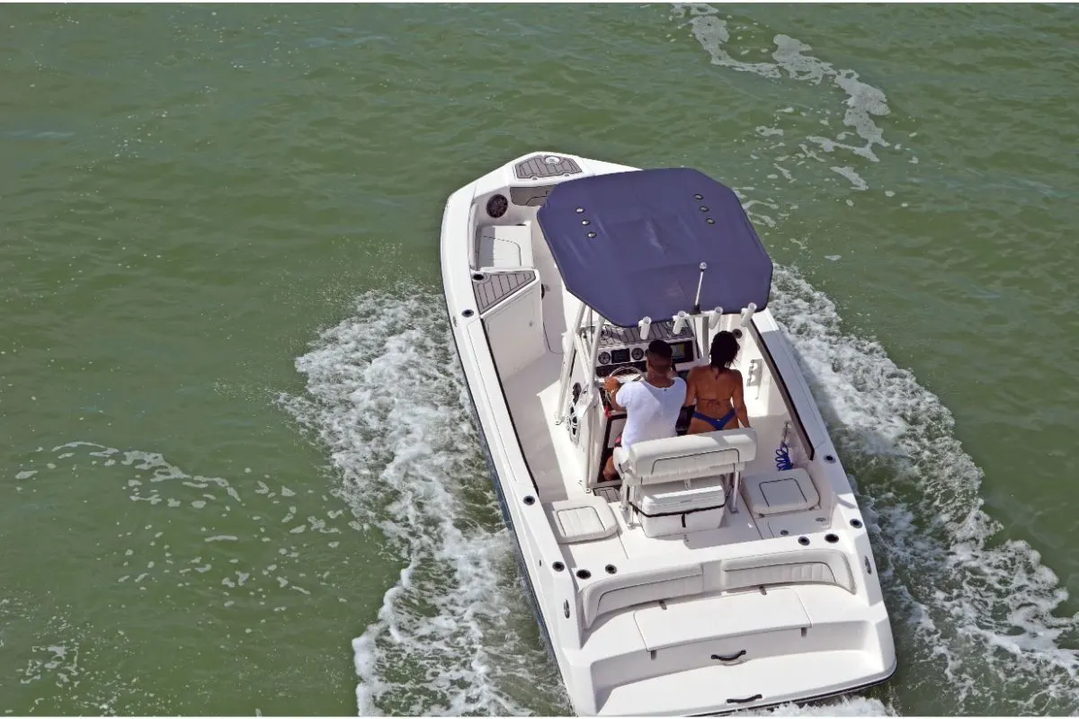 Top view shot of white boat with inboard engine motor driving at the river.