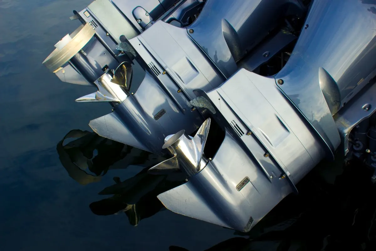 Three motor boat outboard engines in a zoom in angle.