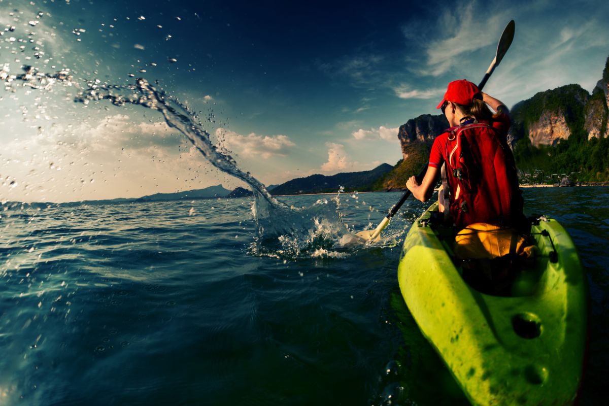 Back view of a woman with the kayak on the water.