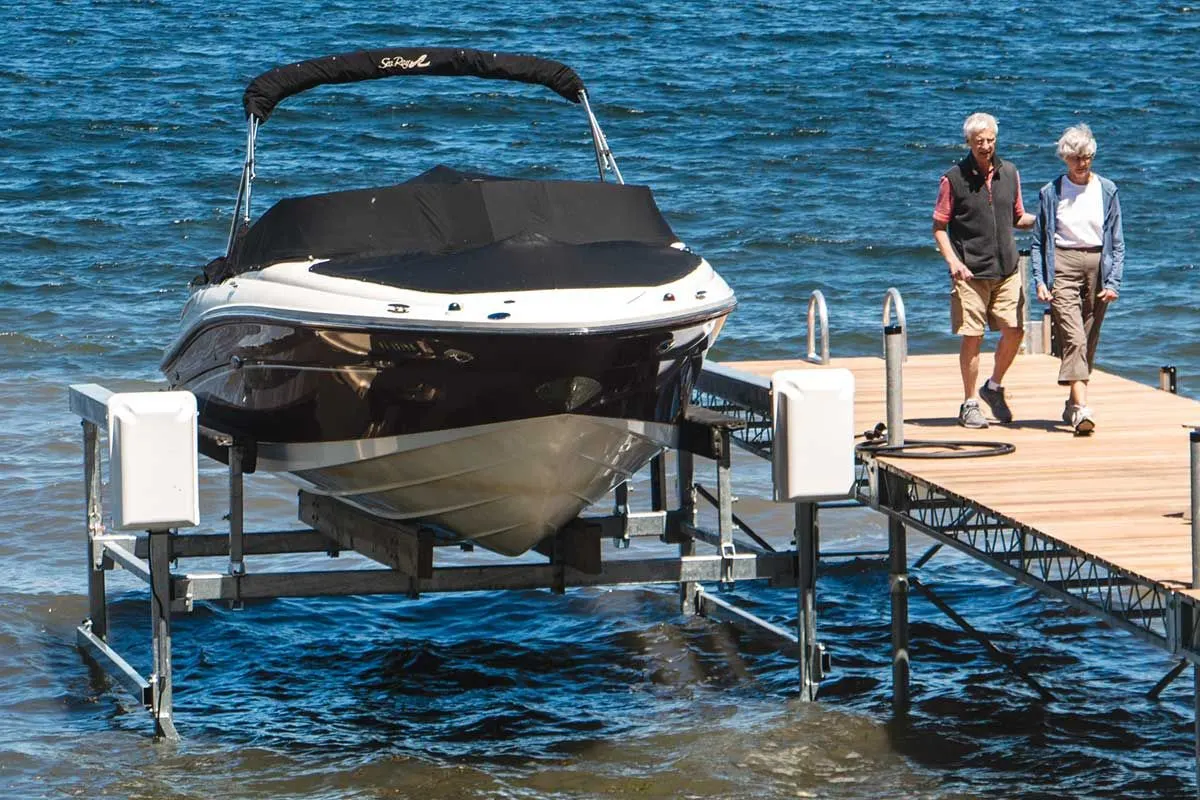 Front view of boat lifted by a vertical lifts for boat at the river.