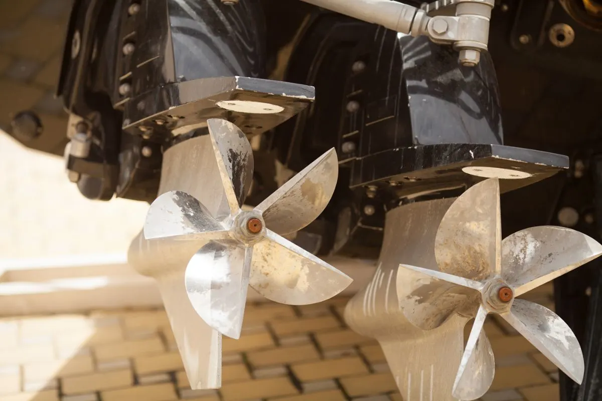 A close-up view of a boat engine with two cleaver blade propeller.