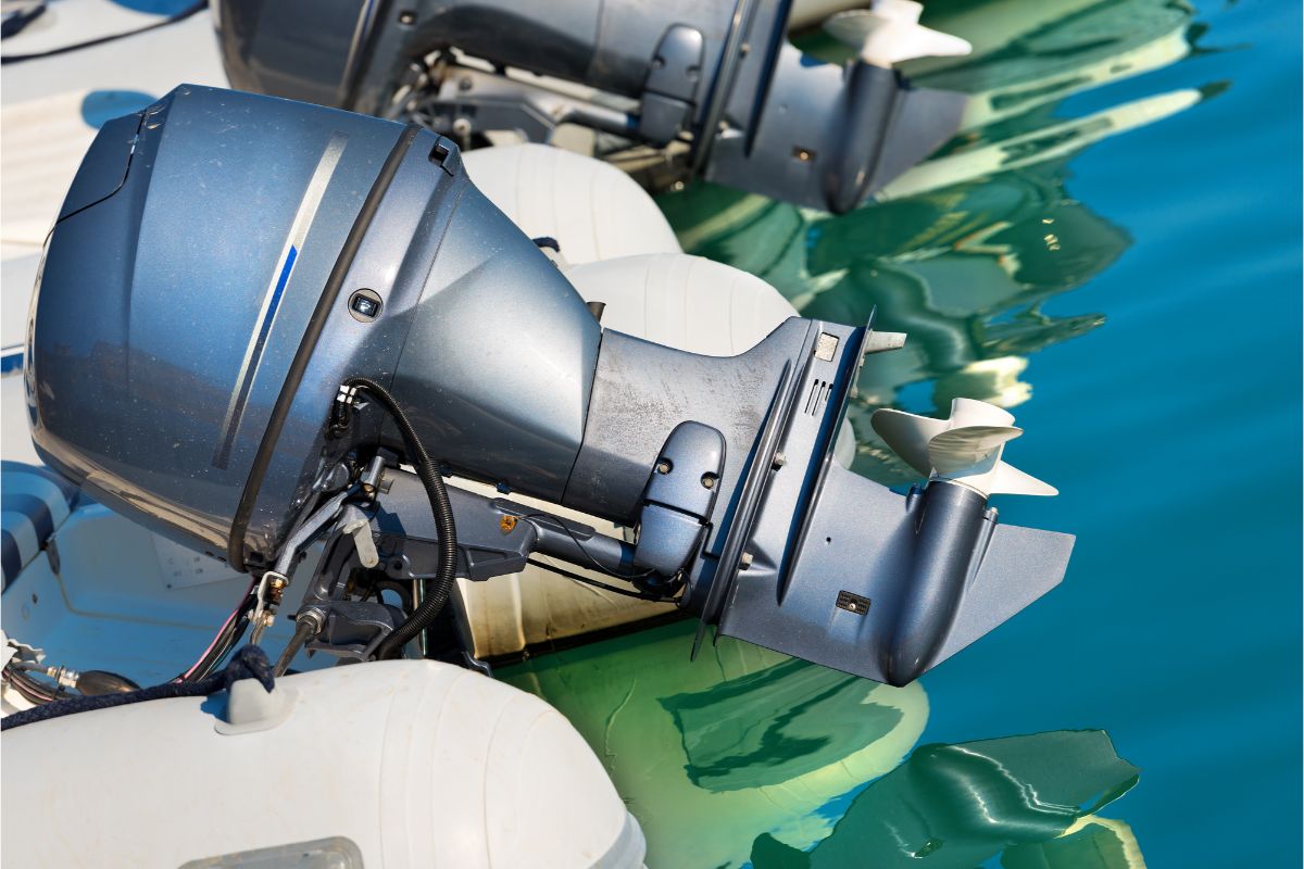 Zoom in angle of an electric outboard engine with cable system almost touching the surface.