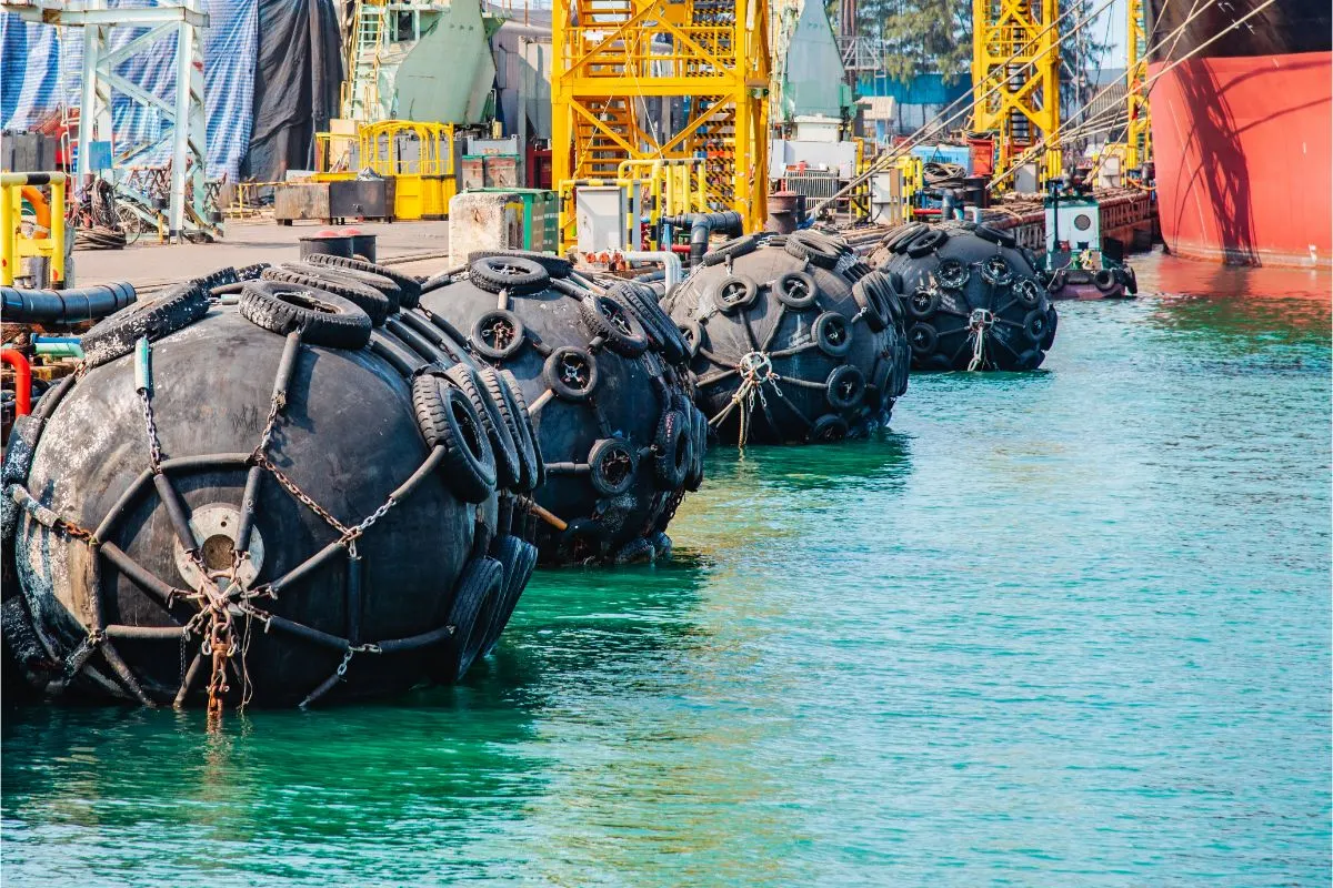 A photo of Floating rubber fenders against at marine vessel damage between.