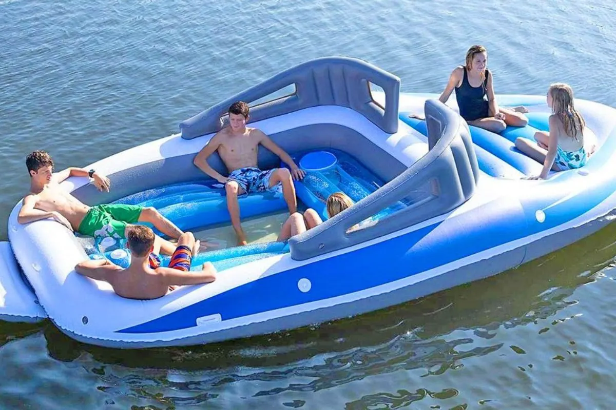 Zoom in photo of a group of friends having fun in a raft-style seat tied up in the yacht.