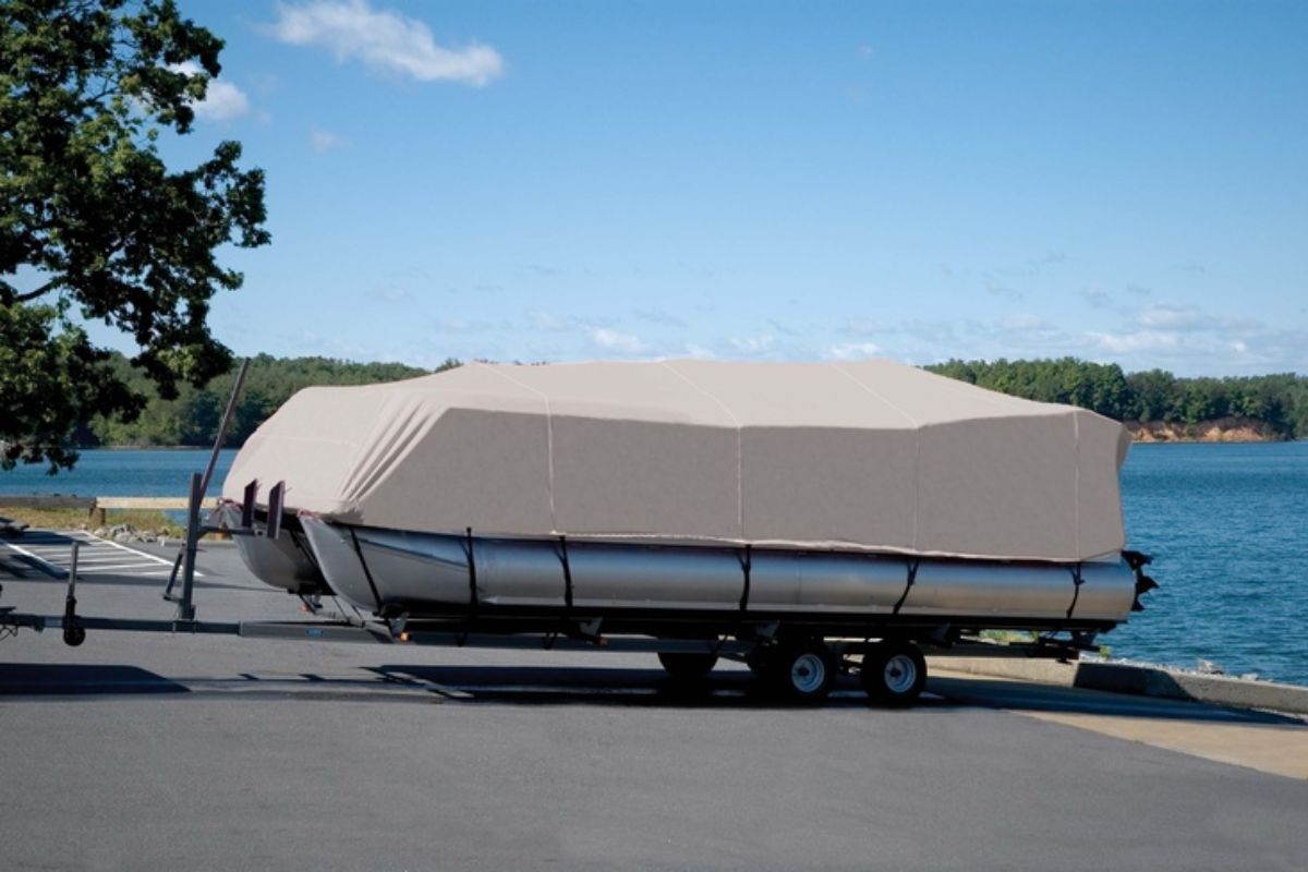 A pontoon boat covered semi-custom fit boat cover to protect it from rain and heat from the sun.