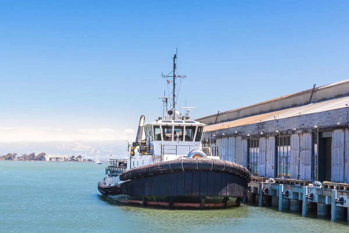 A photo of tow ship at seaport with tugboat fenders.