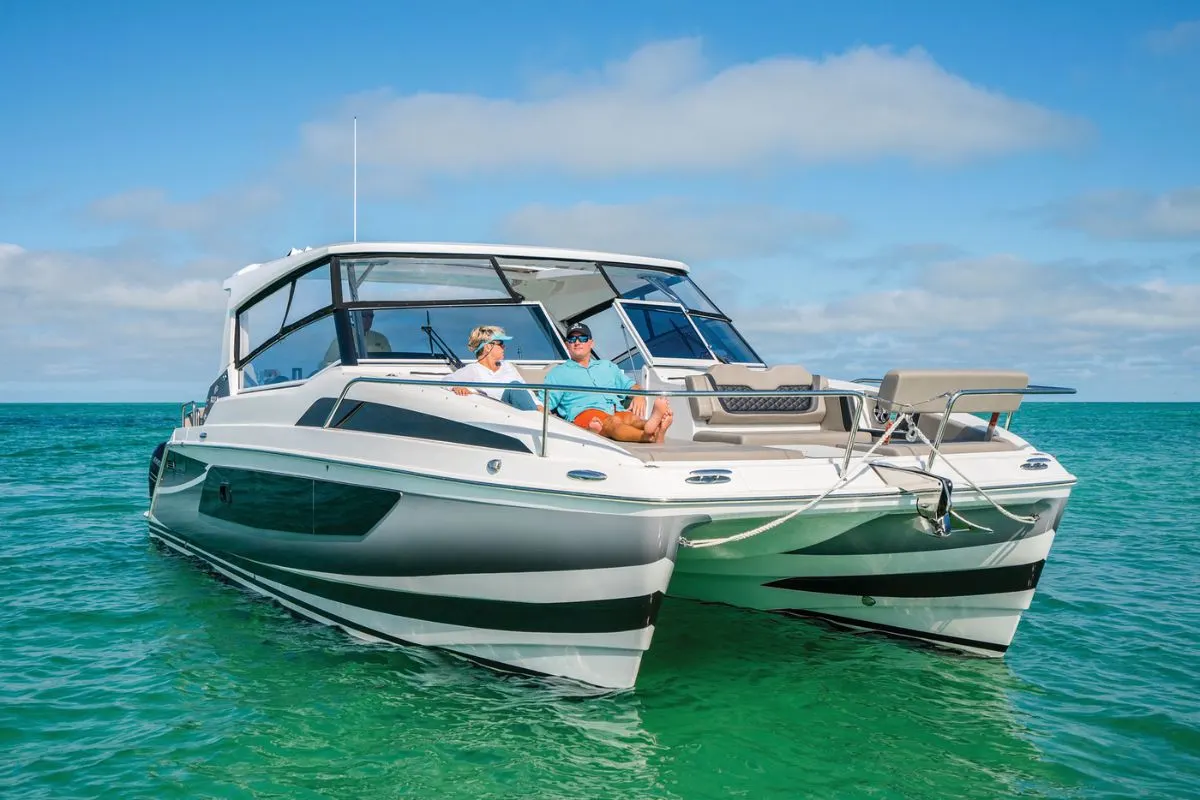 A luxurious Aquilla 36 Sports Catamaran anchored in the crystal clear water.