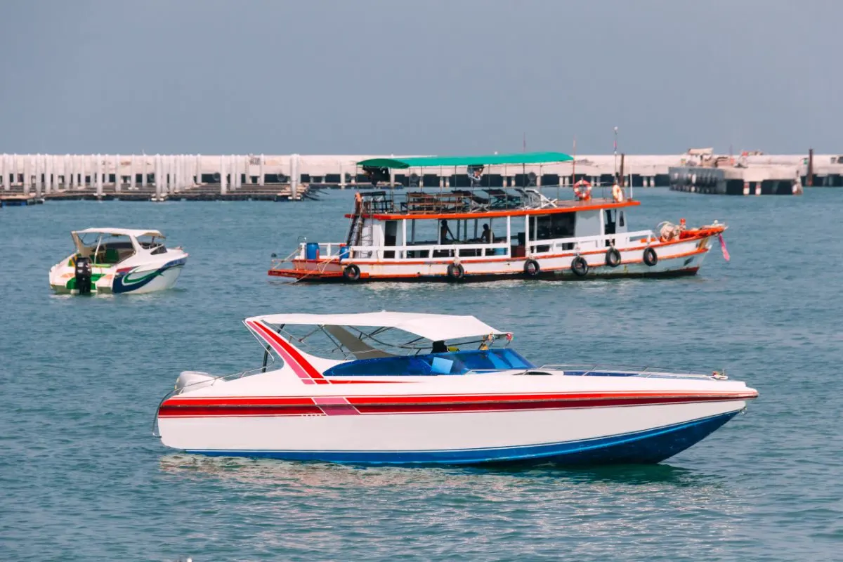 Side view of Bowrider boat with fishing boat and another bowrider in the background.