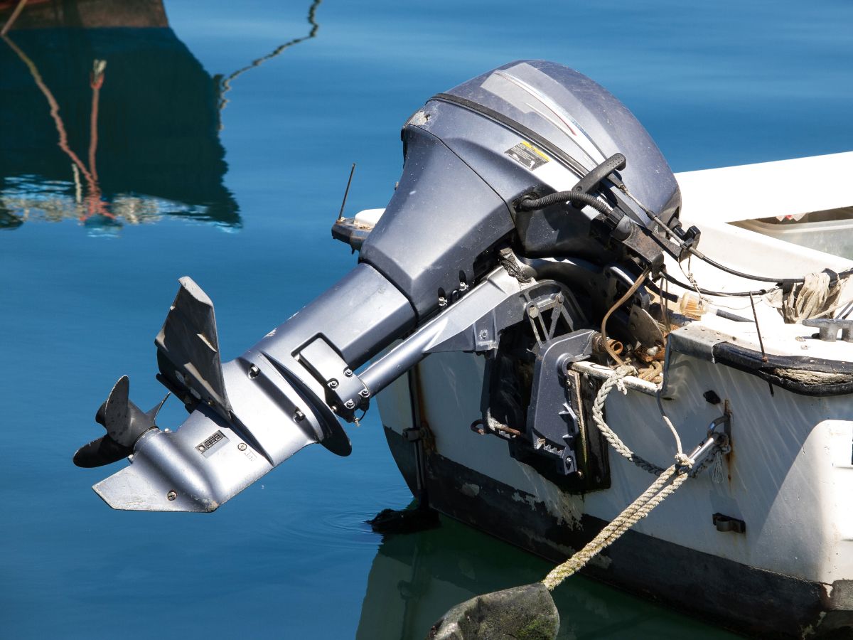 Gray outbord boat motor on the white boat.