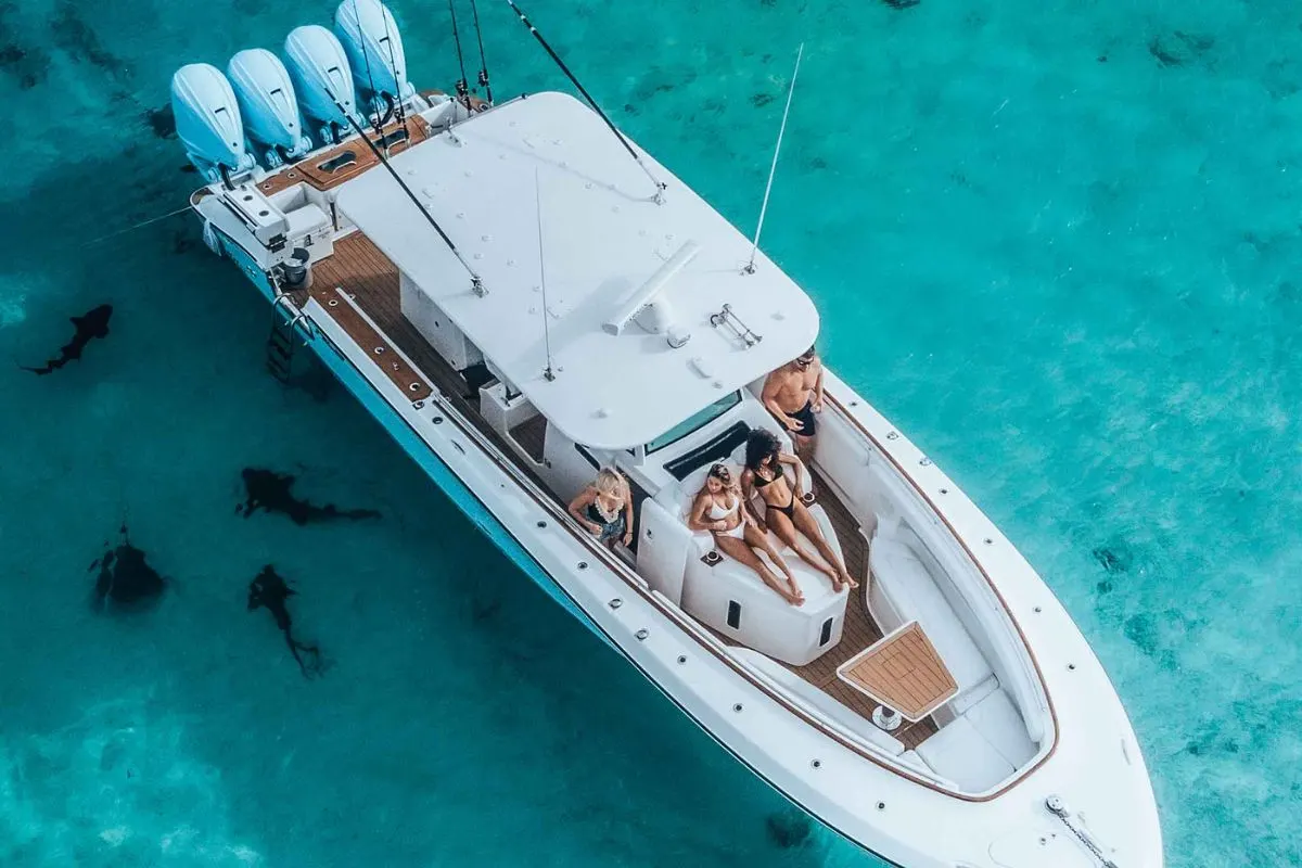  A group of friends in a HCB 42 Lujo yacht anchored in a crystal clear sea.