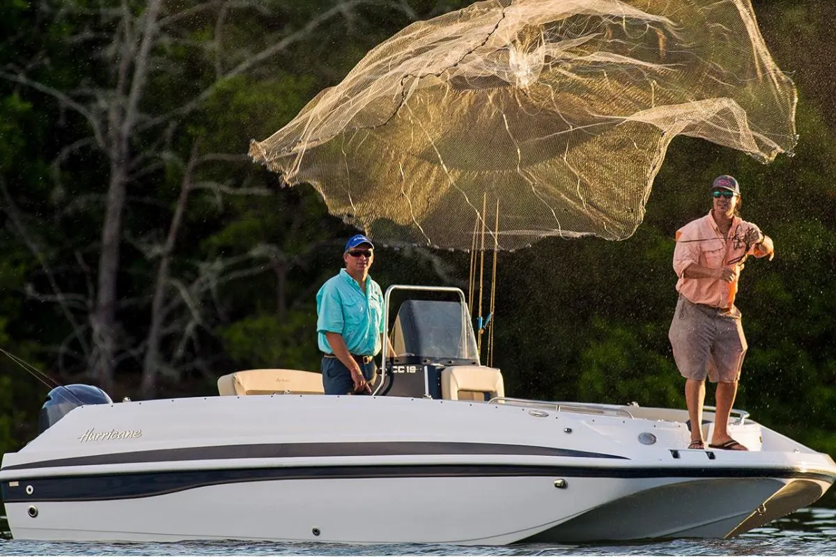 Two men fishing with their Hurricane Center Console 19 OB luxury fishing boat.