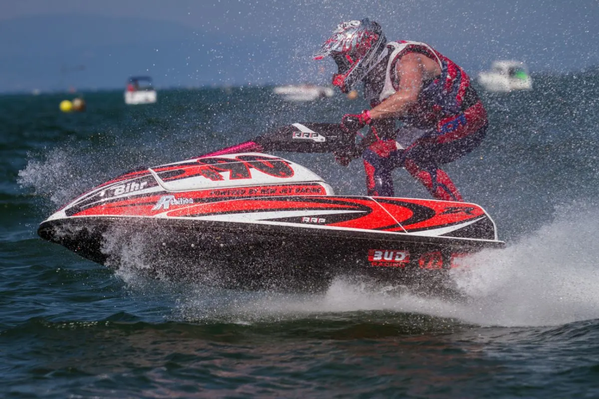 A speed-track competitor riding a jetski at a competition.