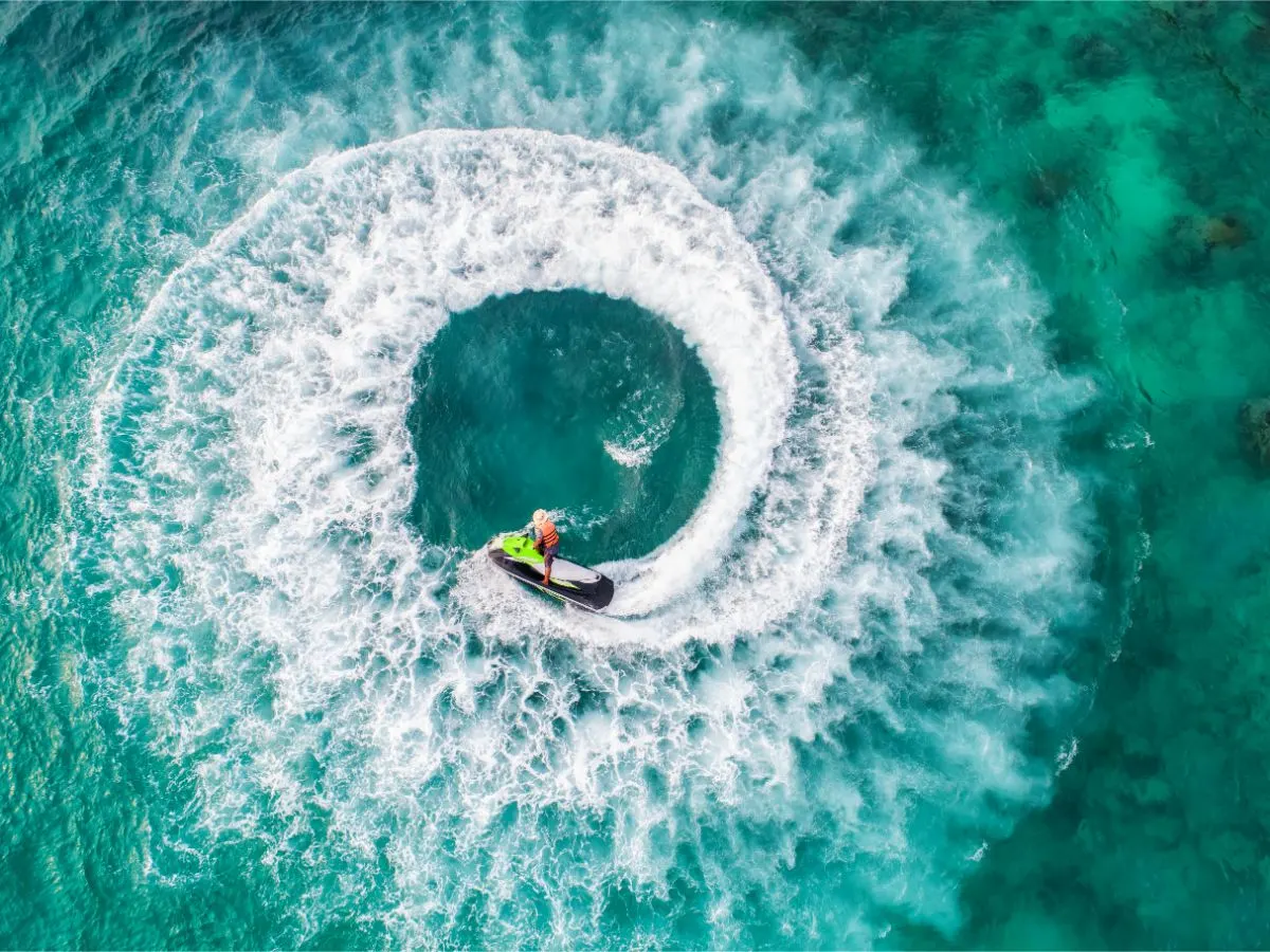 Top view of a person playing a jet ski in the beautifully bright sea.