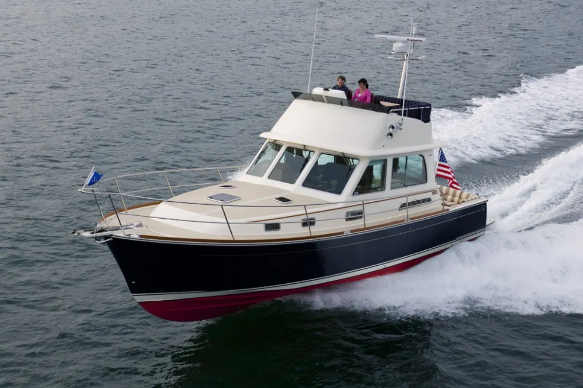 A front view angle of the Sabre 40 Sedan with a couple driving the yacht.