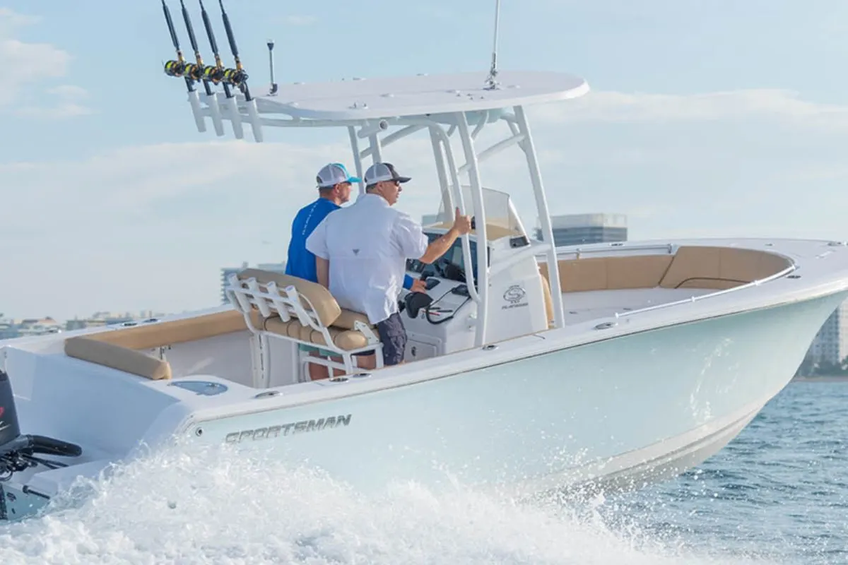 Two men on their Sportsman Open 232 Center Console going full speed on the sea.