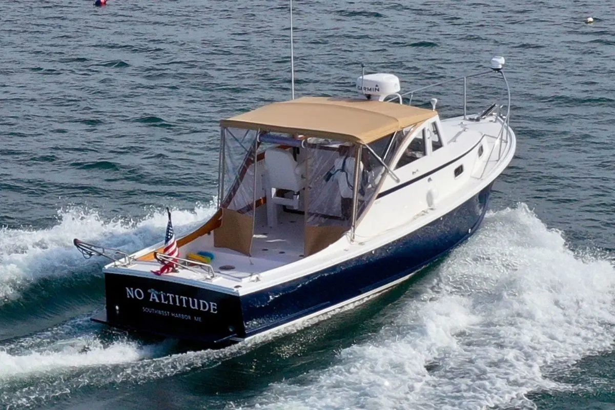 A brnd new legacy 28 express yacht going full speed in the sea.