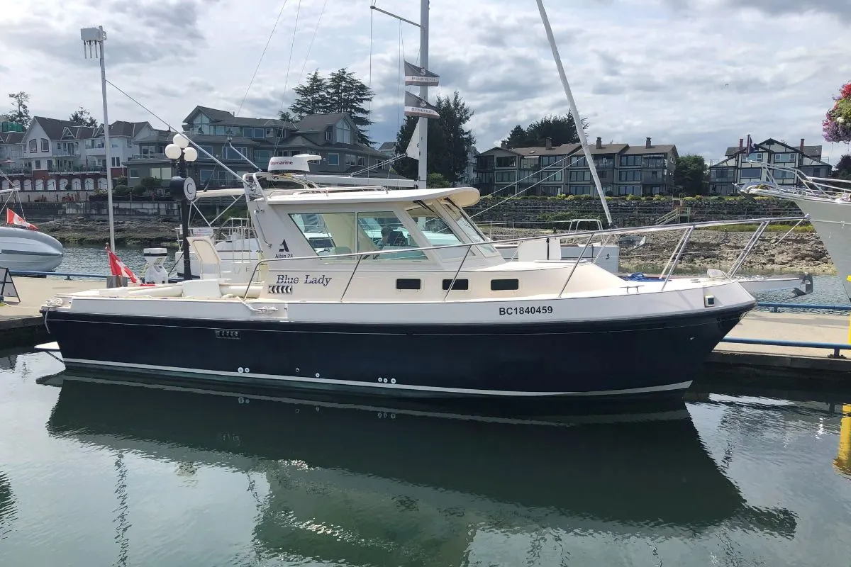 An albin 28 TE for sale anchored in a dock.