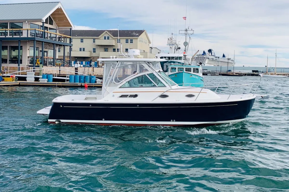 Side view angle of a Back Cove yacht for sale anchored in a dock.