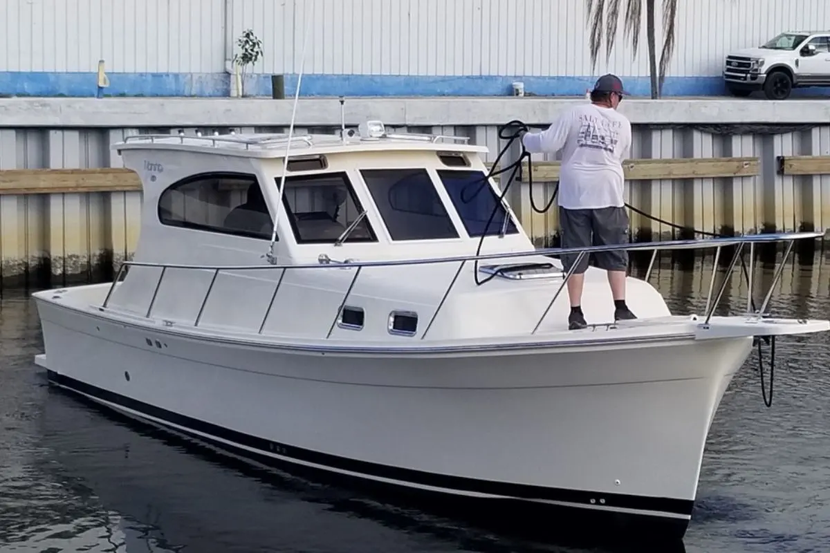 A 2006 model Mainship Pilot 30 Sedan parking in a dock with it's owner.