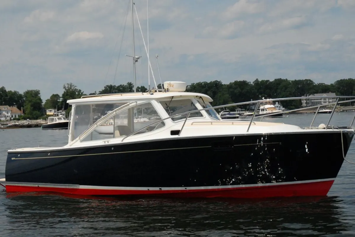 An MJM 29Z yacht with red and black hull colorway anchored in a dock. 