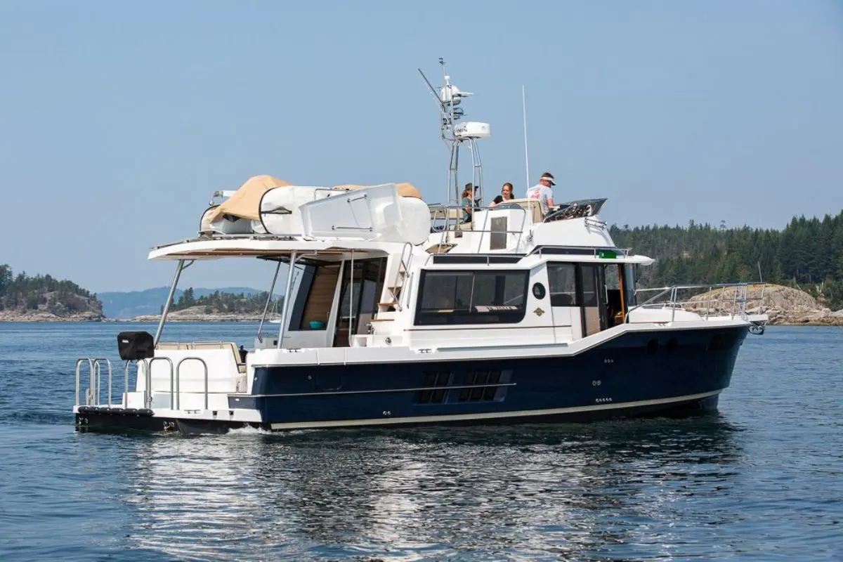 A brand new Ranger Tug with people onboard spotter anchored in the sea.