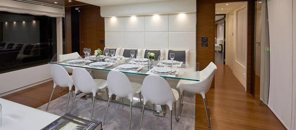 Dining space with a glass-top table paired with modern chairs.