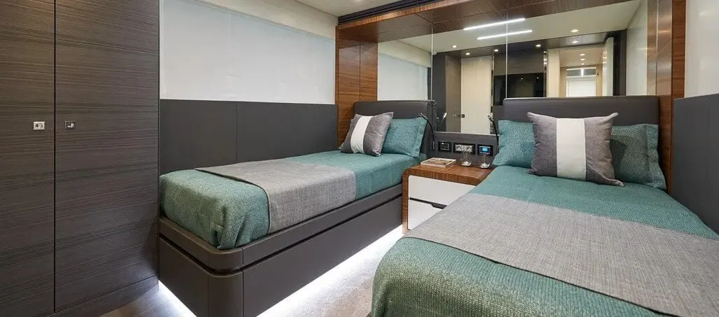 Cabin with two single beds against the mirrored wall.