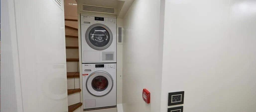 Laundry closet with a stacked washer and dryer.